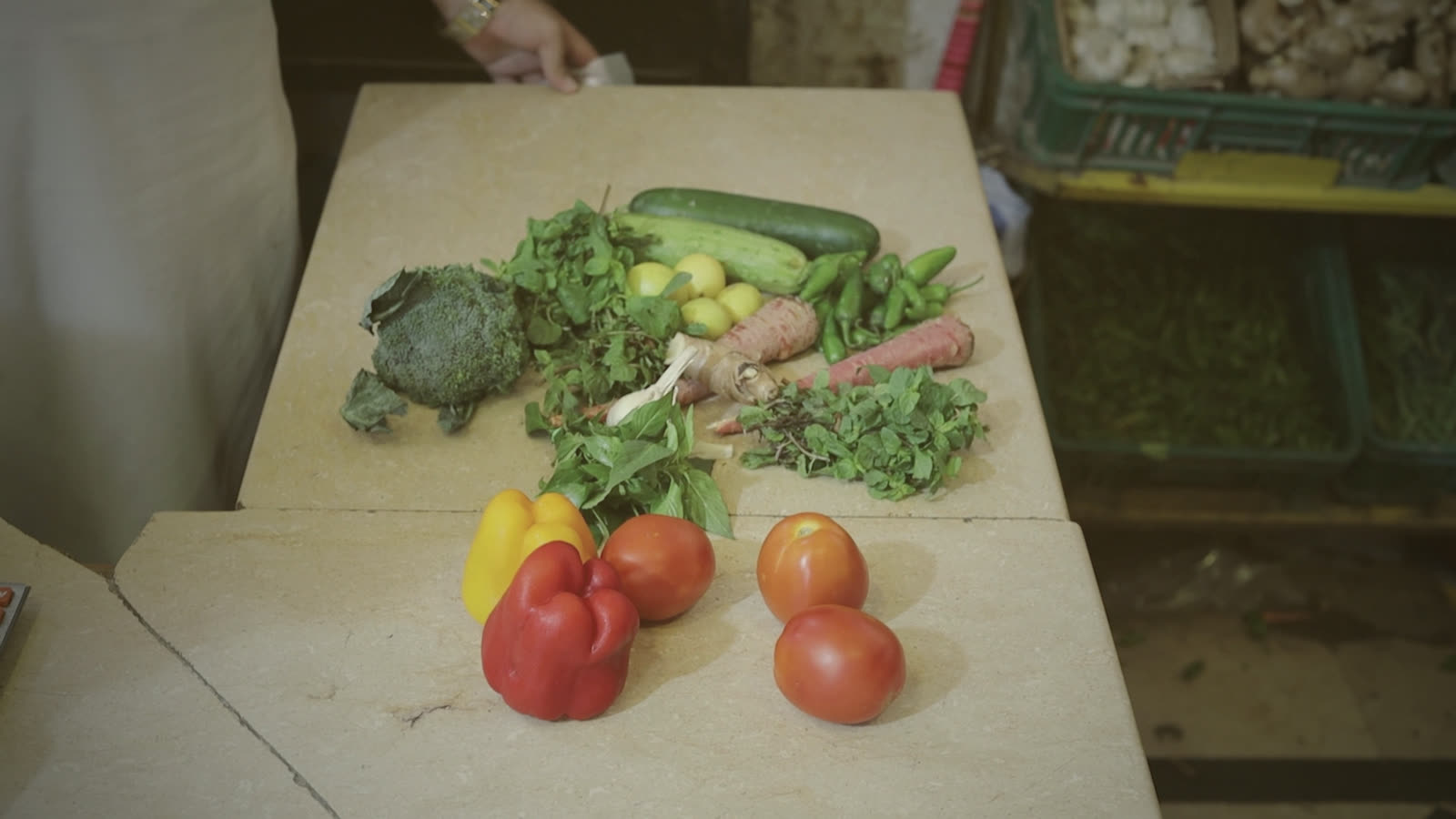 Capsicum, tomatoes, greens and cucumber laid on the counter at the sabzi mandi